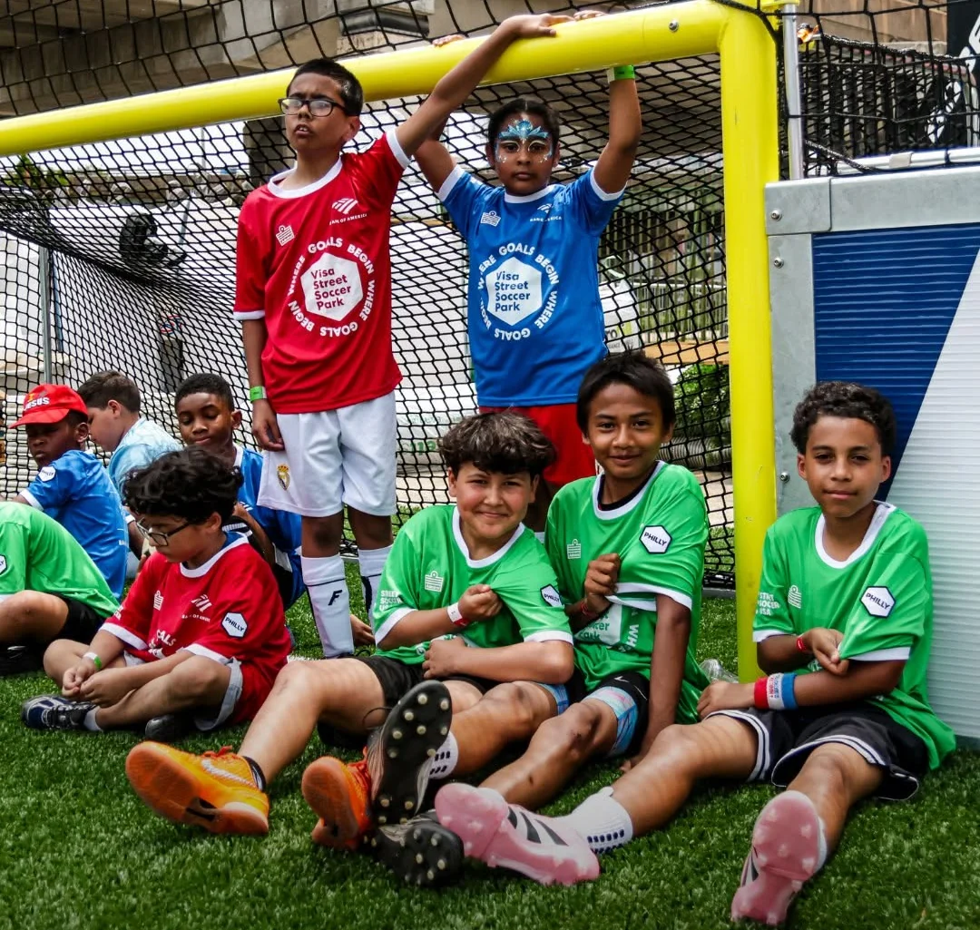 Street Soccer USA players gathered around a small-sided goal